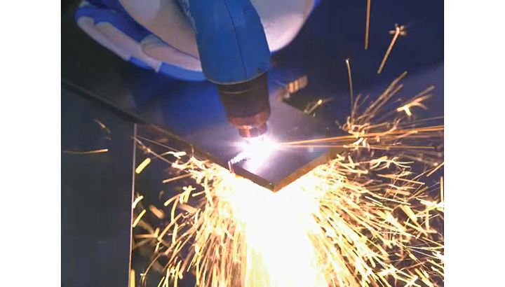 Using a plasma cutter on a piece of metal