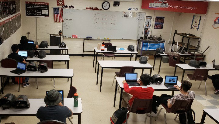Students on laptops in a classroom