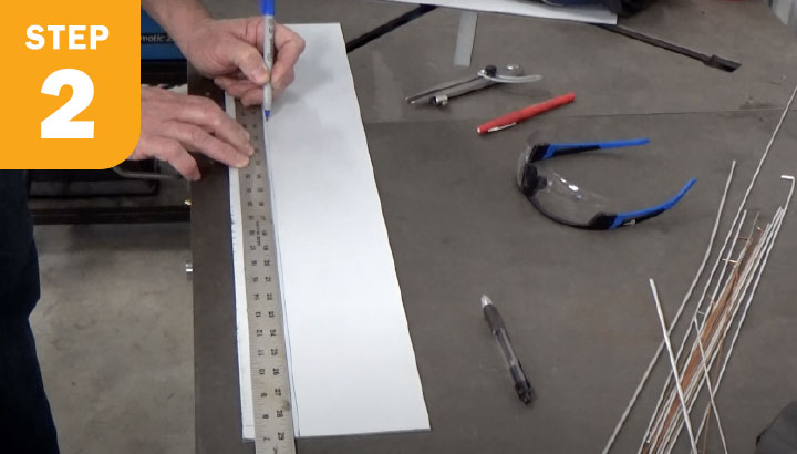 Fabricator making marks on metal piece along ruler